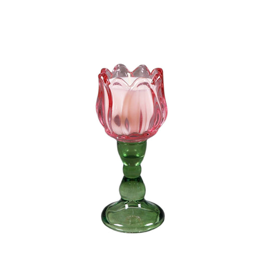 Glass tulip-shaped candle with pink top and green base on a white background