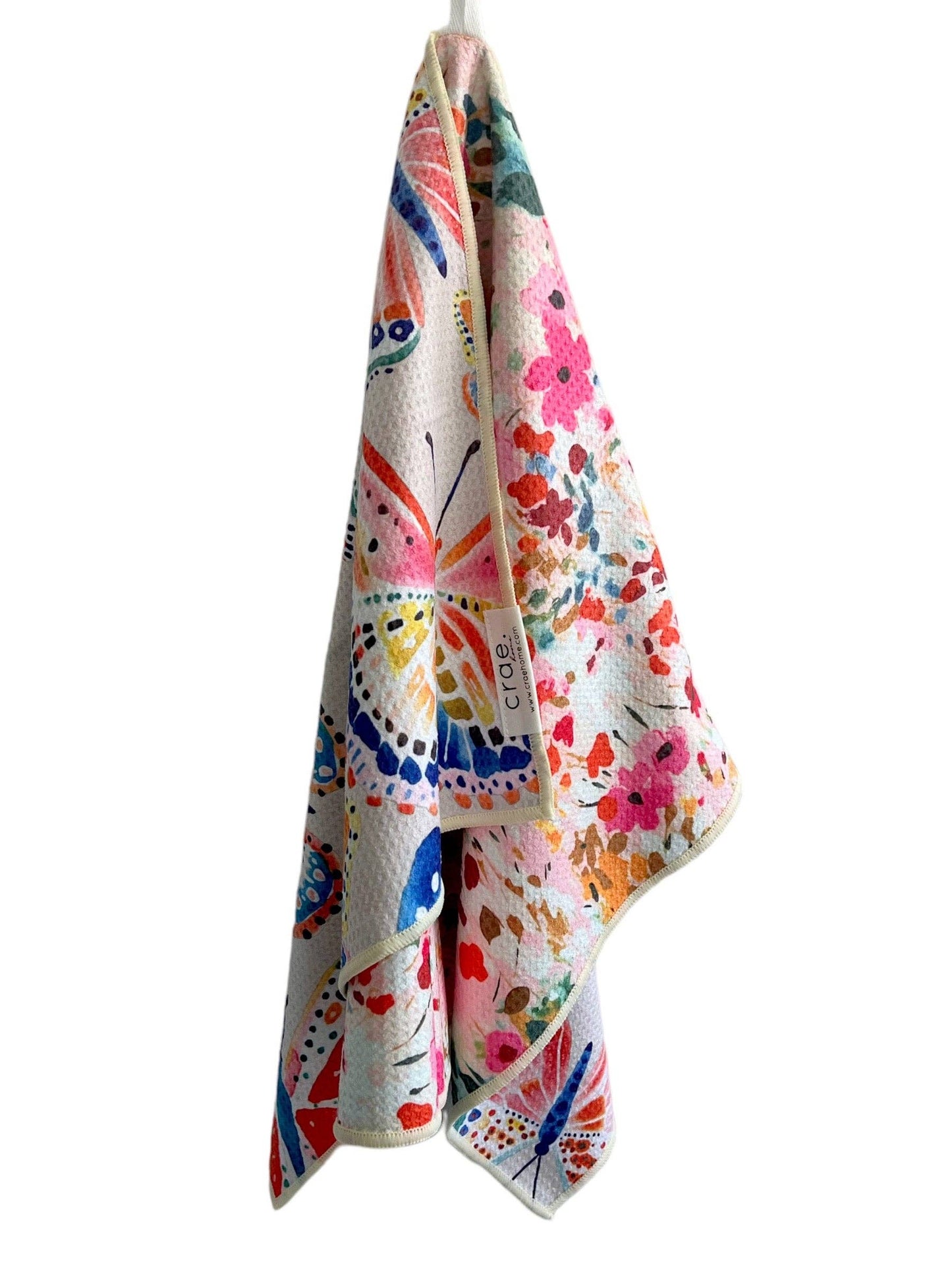 Colorful towel with abstract patterns hanging on a white background