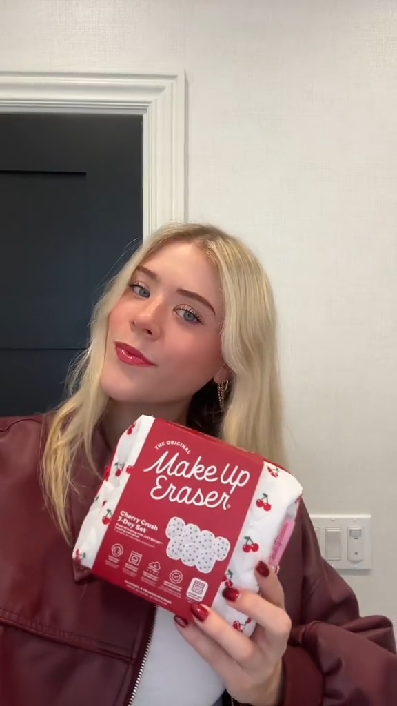 Person holding a red box labeled 'Makeup Eraser' against a neutral background