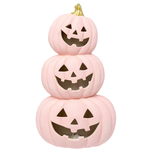Stack of three pink jack-o'-lanterns with carved faces on a white background