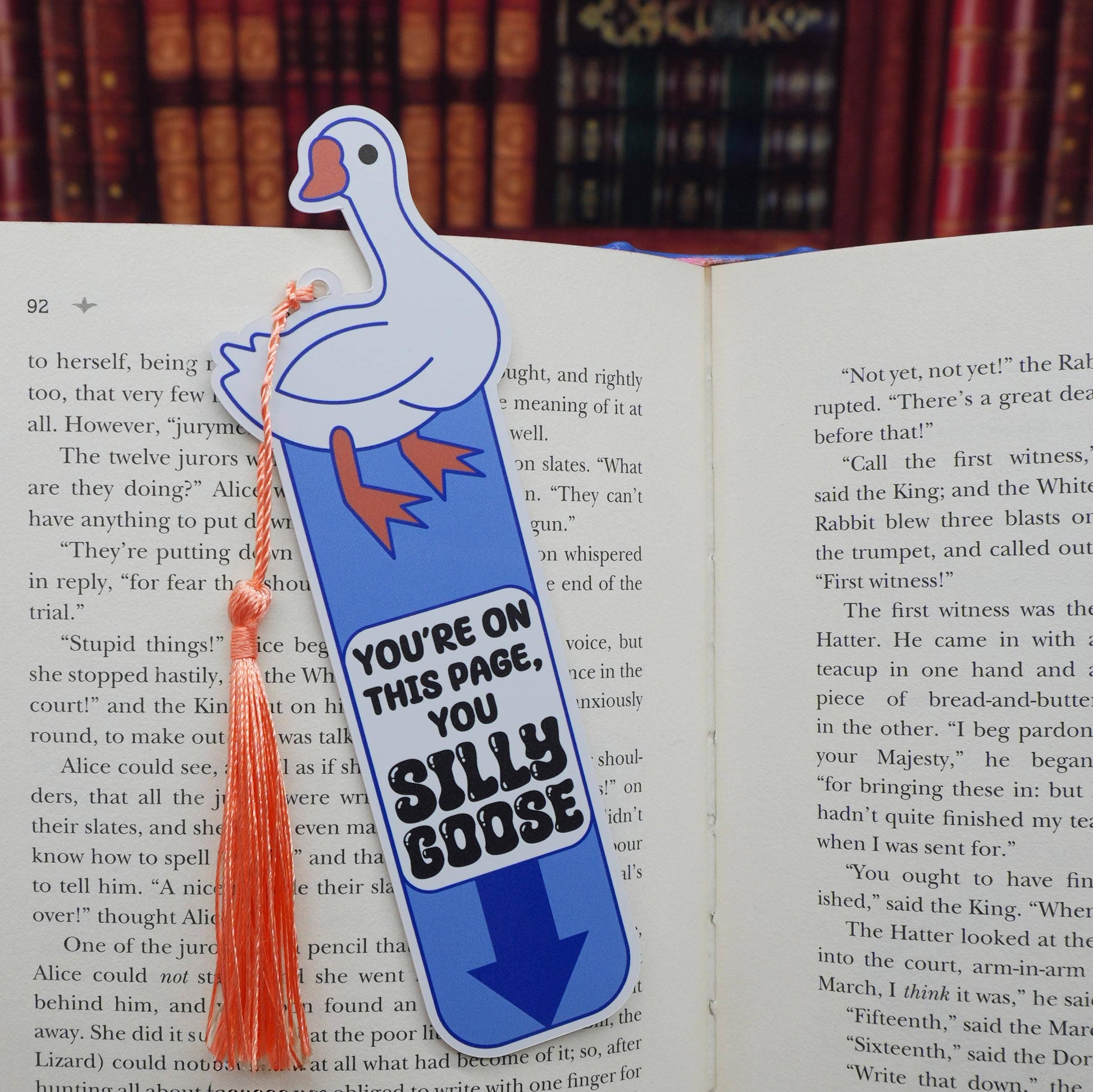 Bookmark shaped like a goose with text 'YOU'RE ON THIS PAGE, YOU SILLY GOOSE' on an open book.