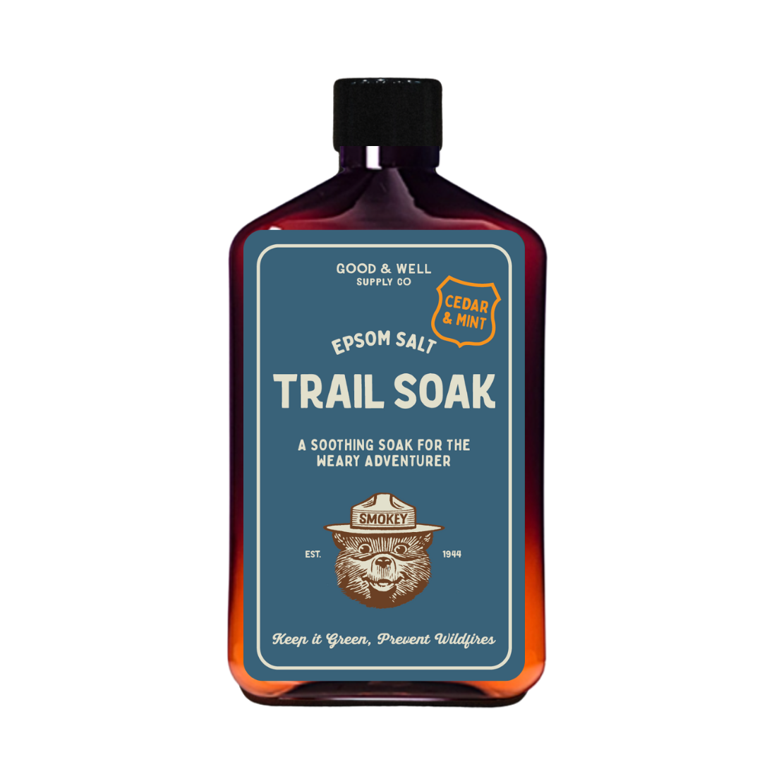 Bottle of Epsom salt trail soak with branding on a white background
