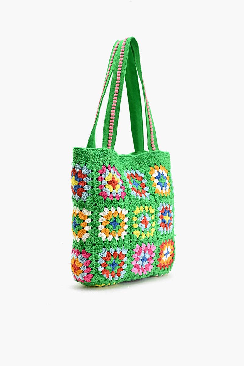 Colorful crochet bag with floral patterns on a white background