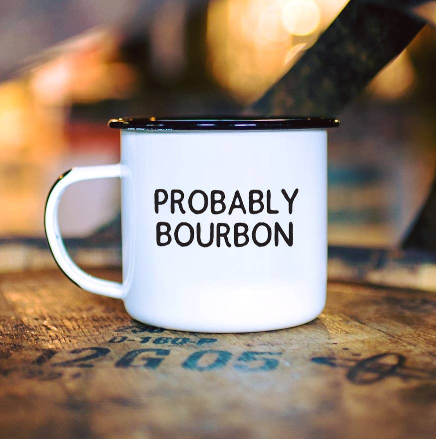 White mug with 'PROBABLY BOURBON' text on a wooden surface