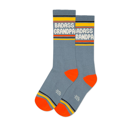 Gray socks with red toes and yellow accents featuring the text 'BADASS GRANDPA' on a white background.