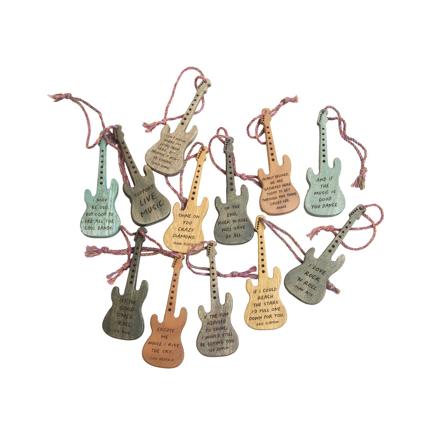 Set of colorful guitar-shaped keychains with strings on a white background