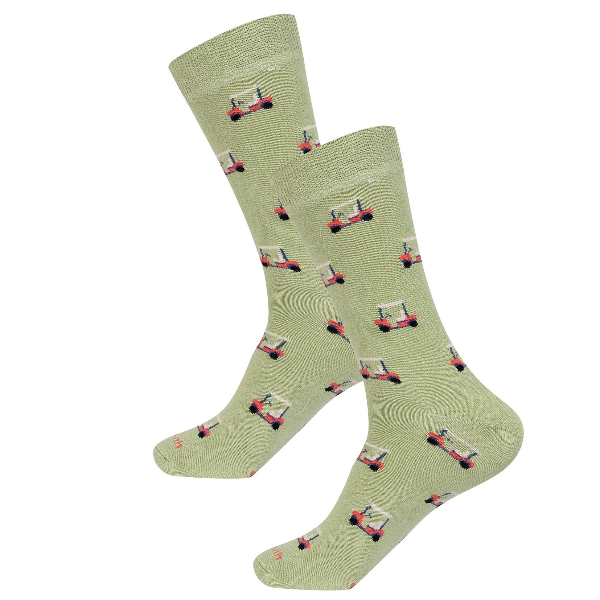Pair of green socks with red and black patterns on a white background