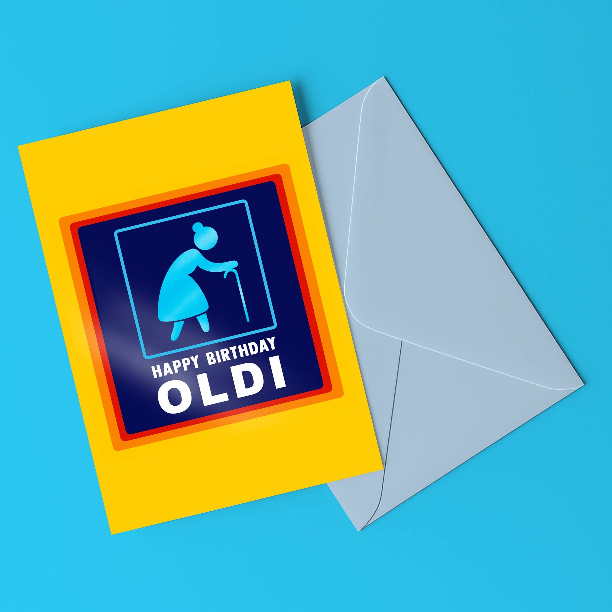 Birthday card with blue icon and text 'Happy Birthday Oldi' on a yellow border, with a gray envelope on a blue background.