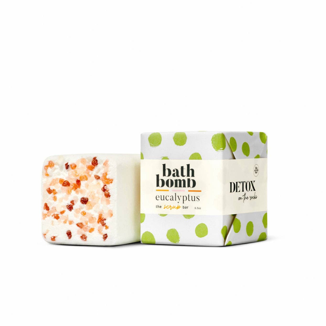 Himalayan Salt infused bath bomb with green polkadot decorative packaging on a white background