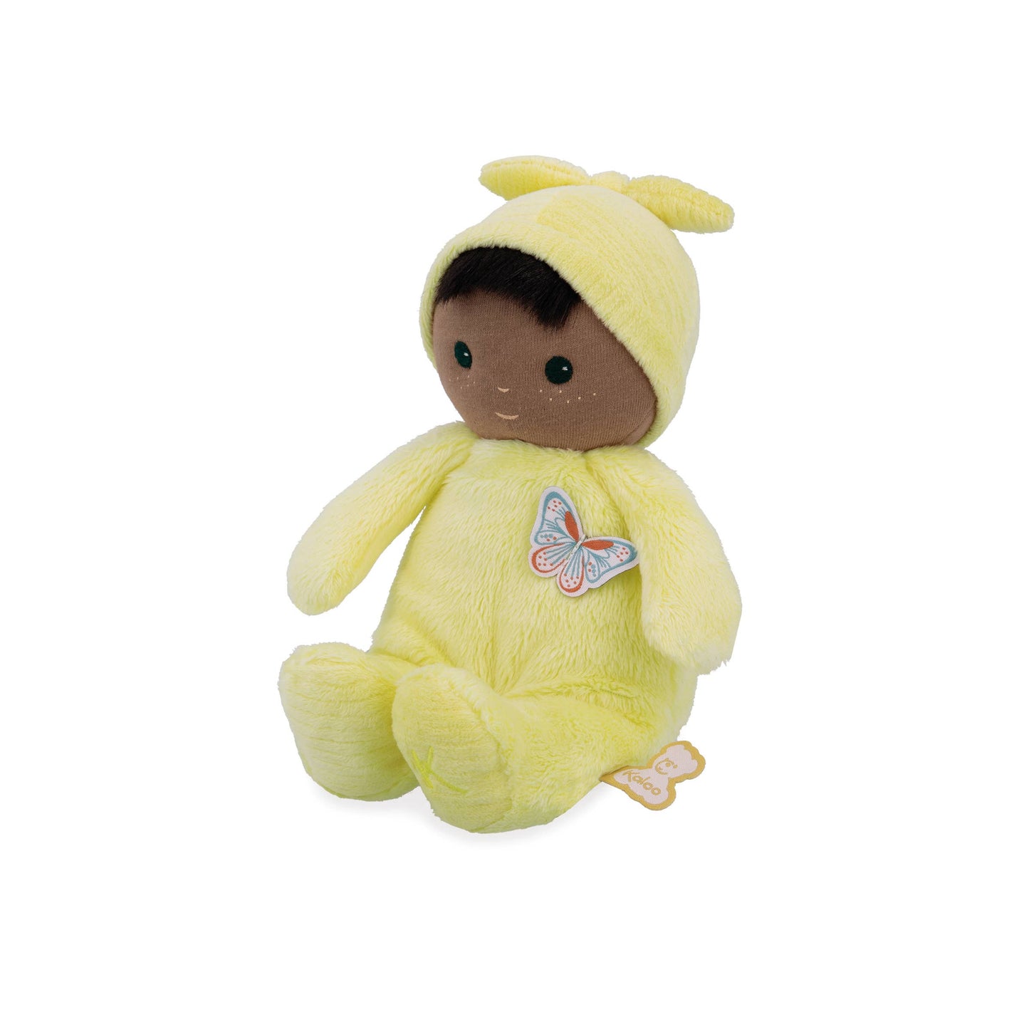 Plush toy baby in a yellow outfit with a butterfly patch on a white background
