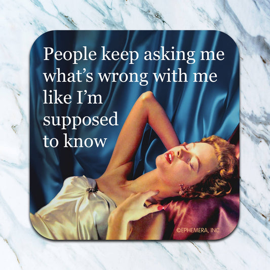 Coaster with a quote and an image of a woman lying on a blue fabric background.