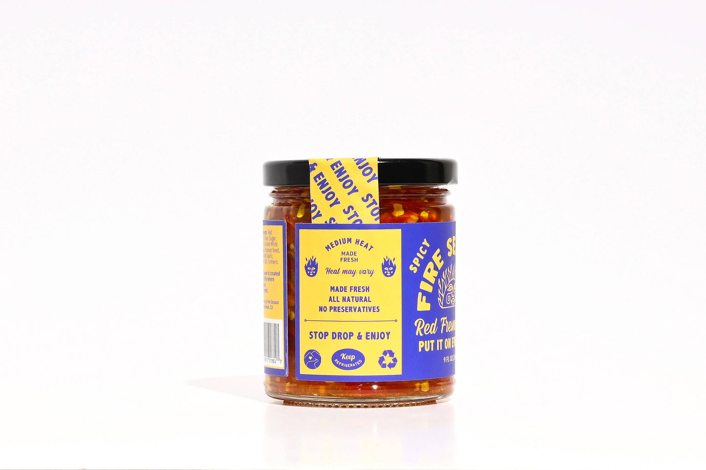 Jar of spicy red pepper flakes with a blue label on a white background