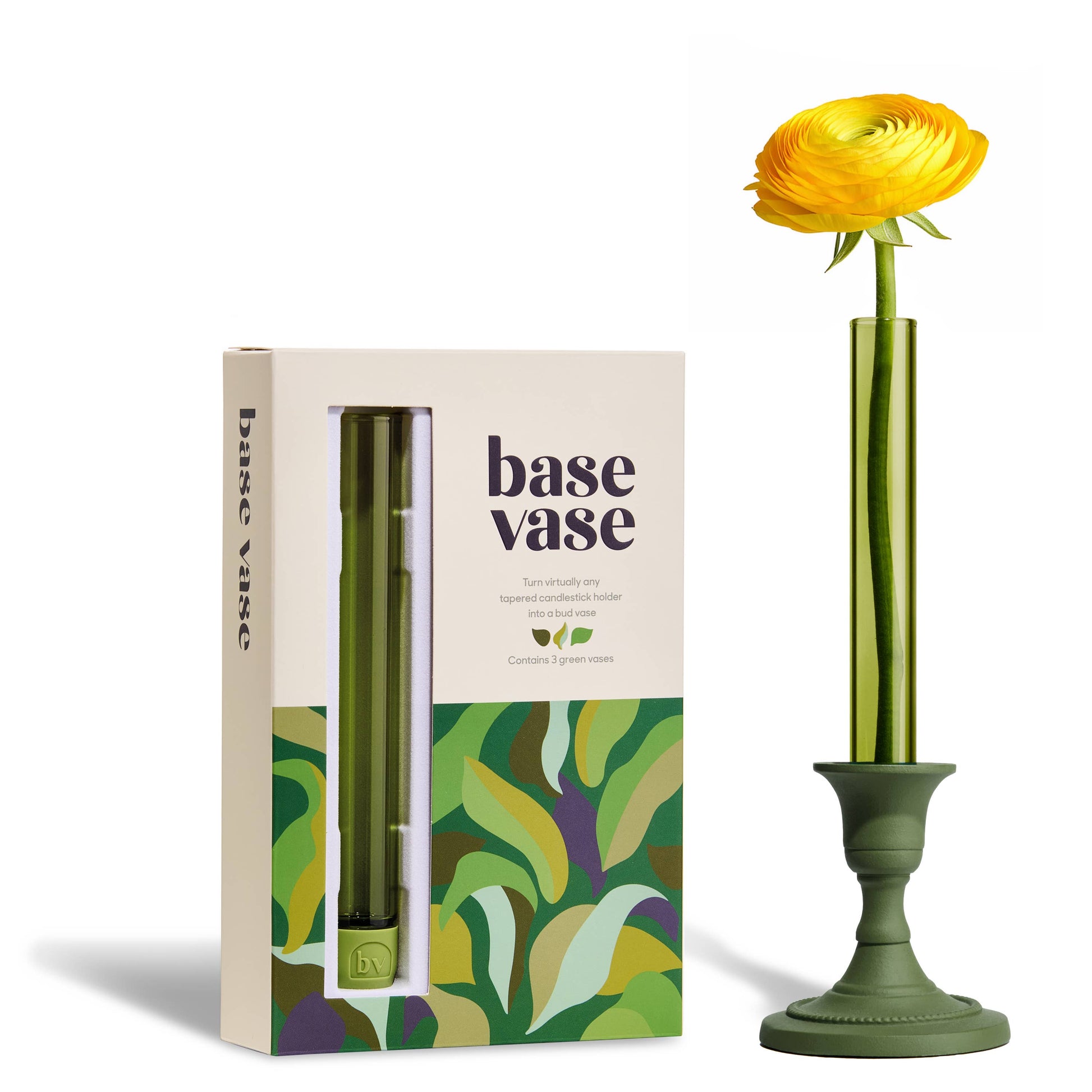 Green vase with a yellow flower next to its packaging on a white background
