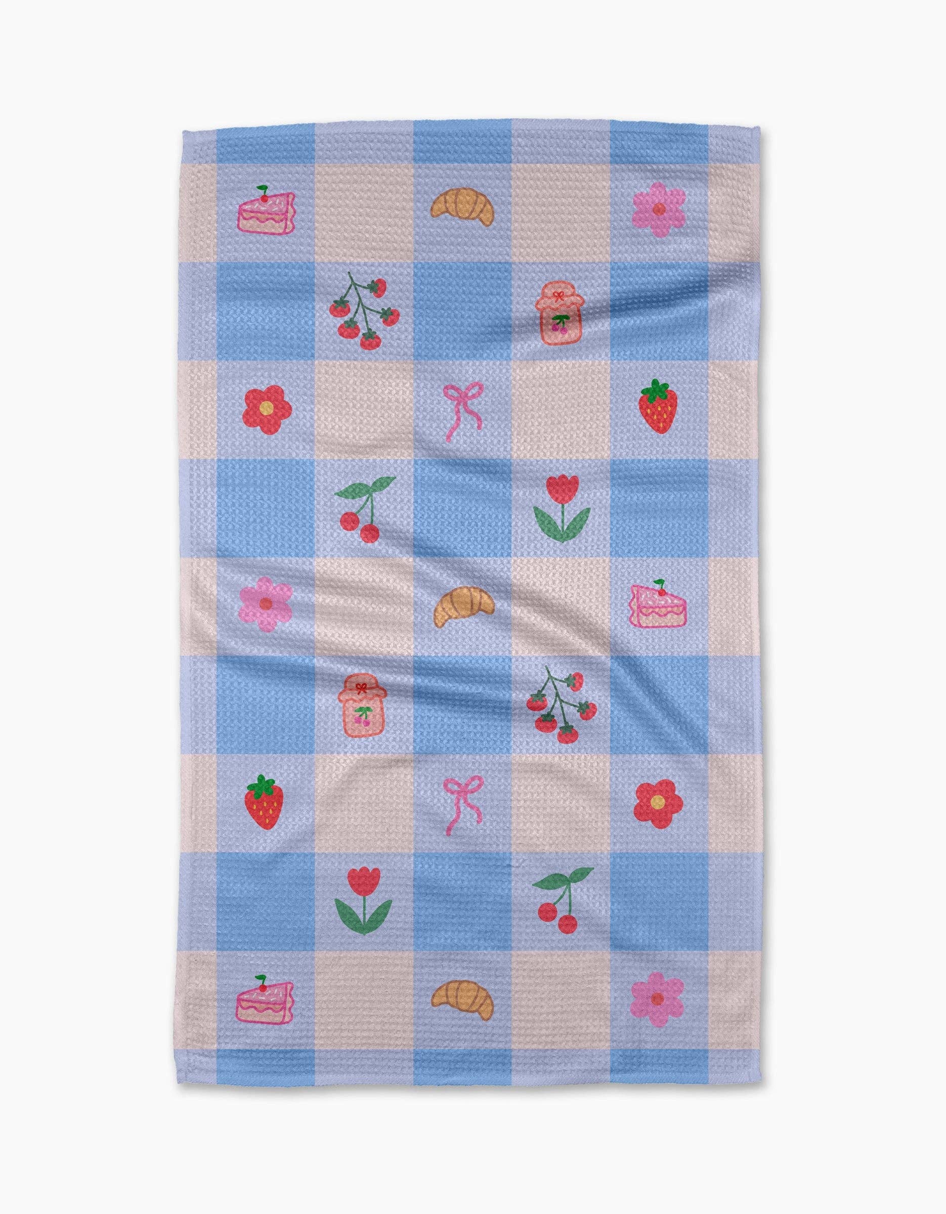 Checkered towel with embroidered designs on a white background