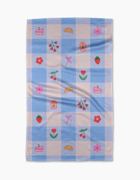 Checkered towel with embroidered designs on a white background
