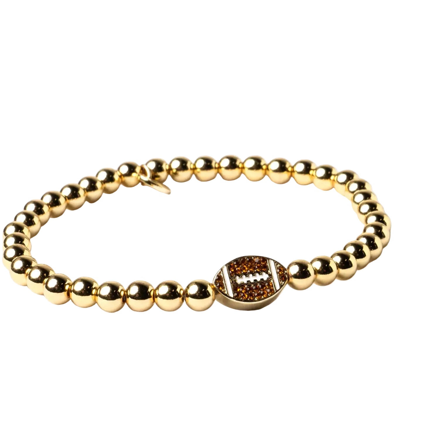 A gold beaded stretch bracelet featuring a central oval football charm embellished with small brown stones and a white lacing detail, set against a plain white background.