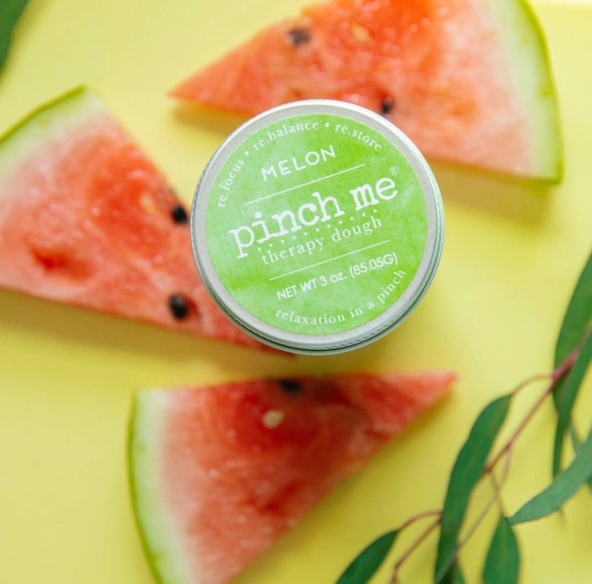 Pinch Me therapy dough container with watermelon slices on a yellow background