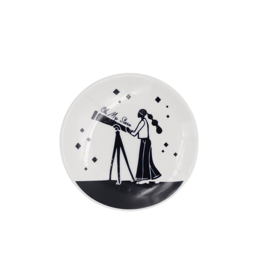 Decorative plate with black and white design of a person with a telescope on a white background
