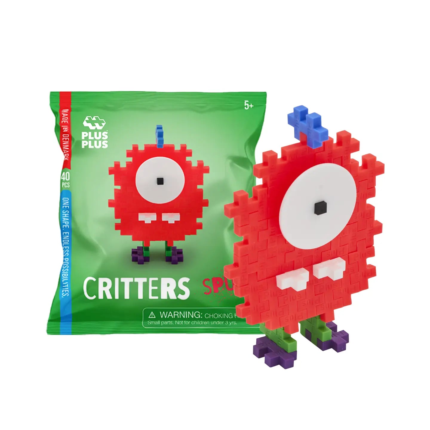 Red pixelated toy figure next to its packaging on a white background