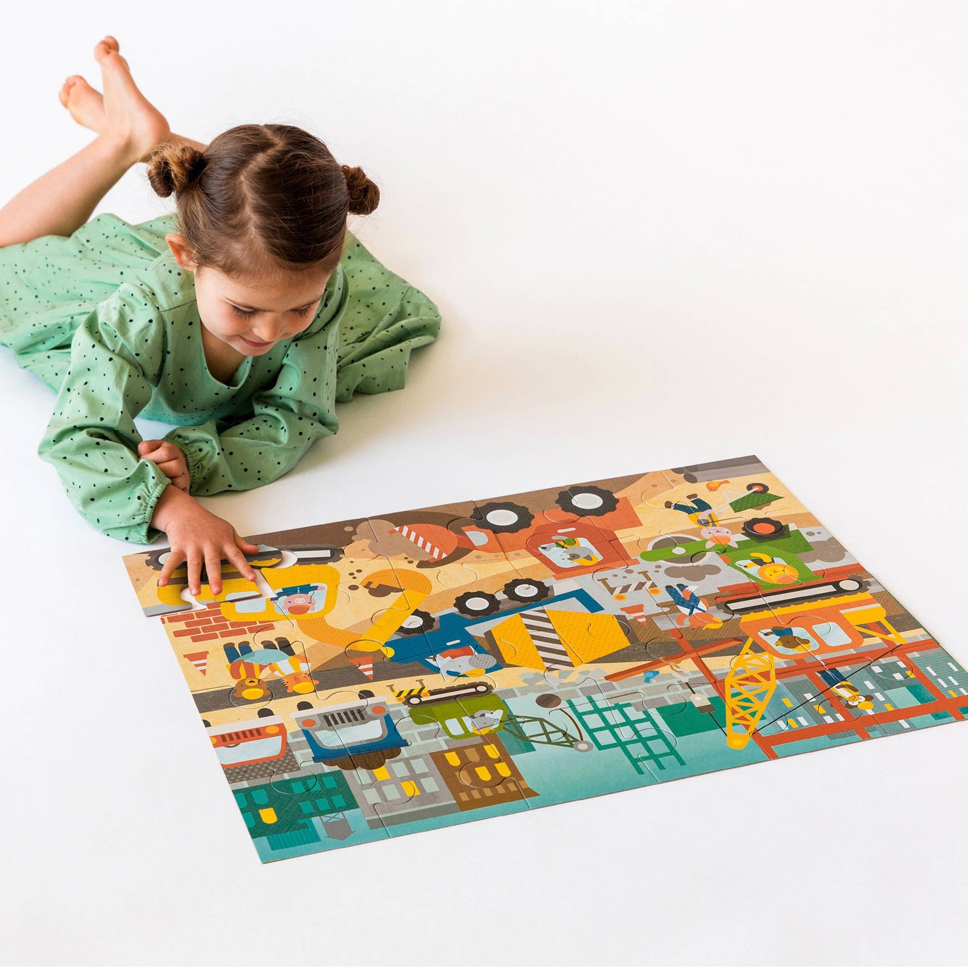 Child playing with a colorful puzzle on a white floor