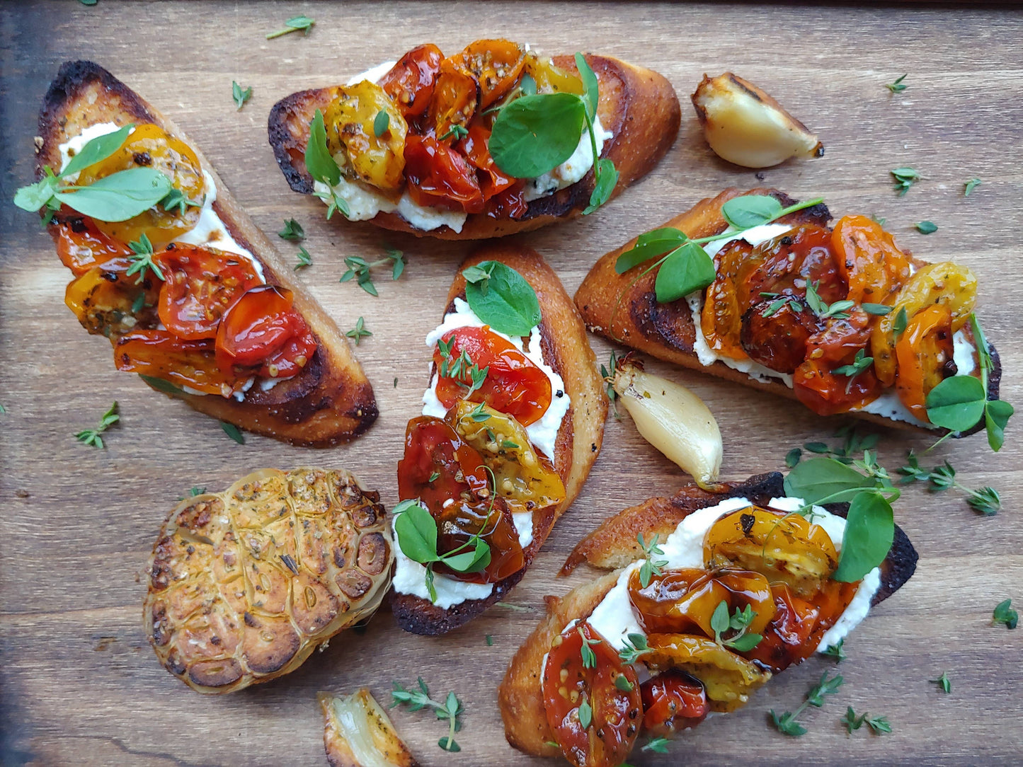 Crostini with tomato and cheese on a wooden board