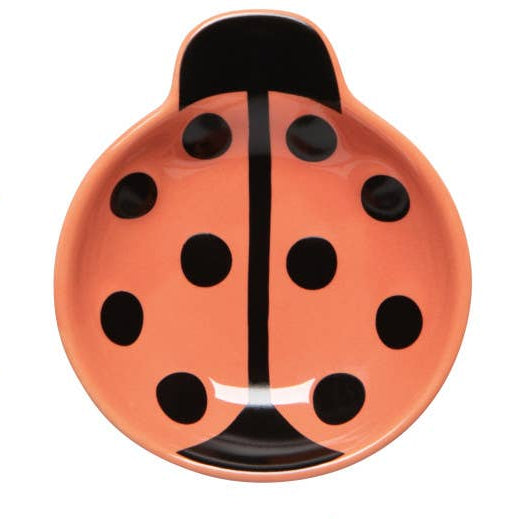 Peach colored lady bug shaped bowl on a white background