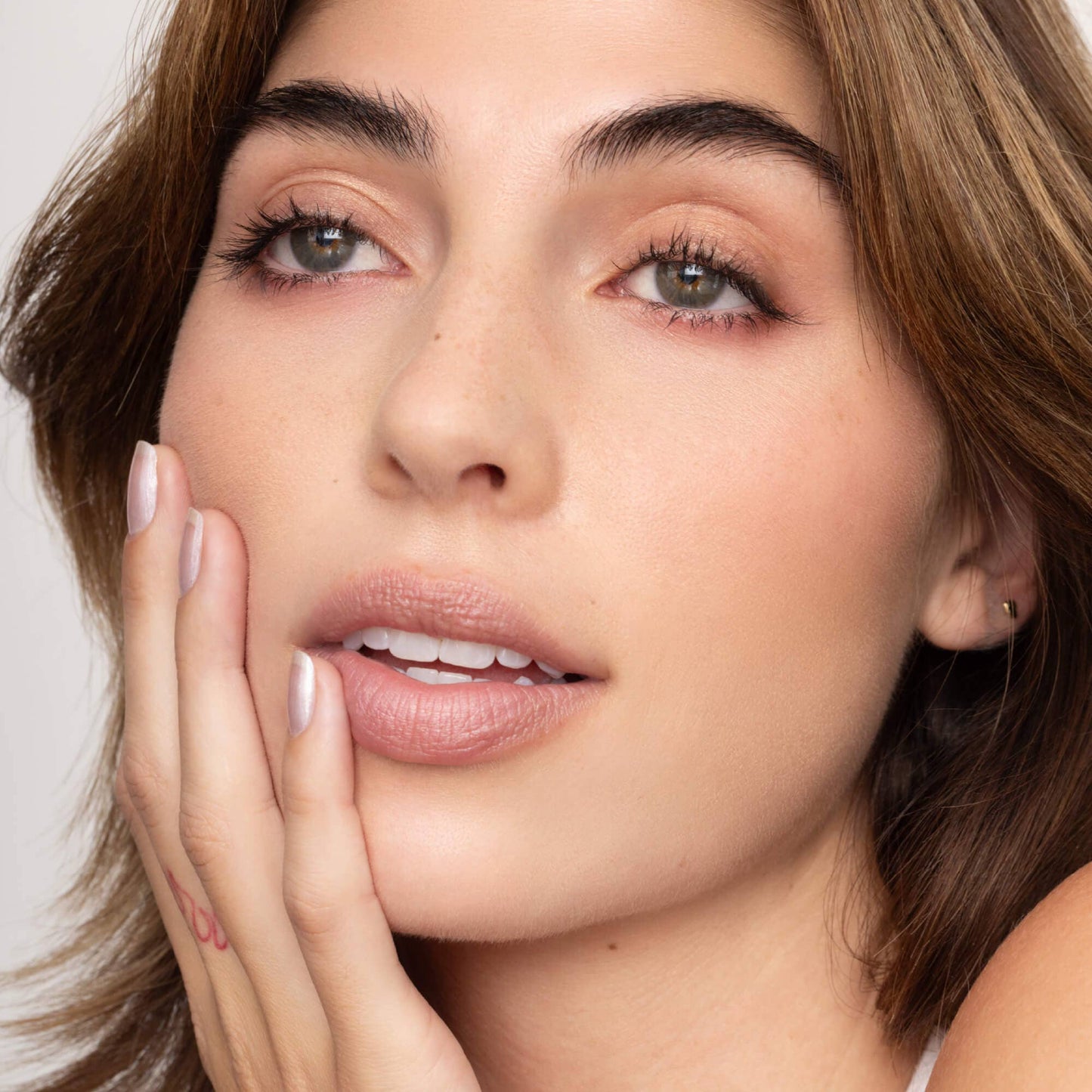 Close-up of a woman's face with a neutral background