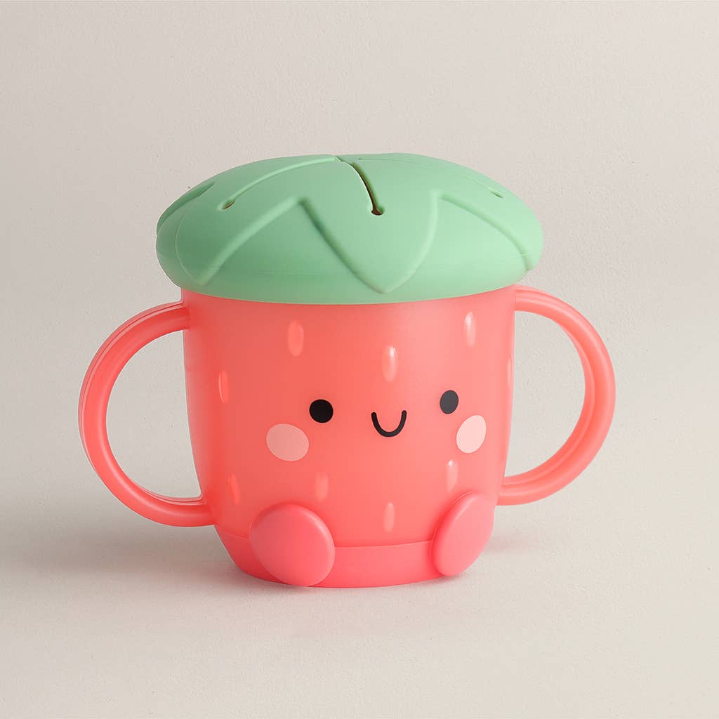 Baby snack cup that looks like a strawberry with a face and a silicone lid 