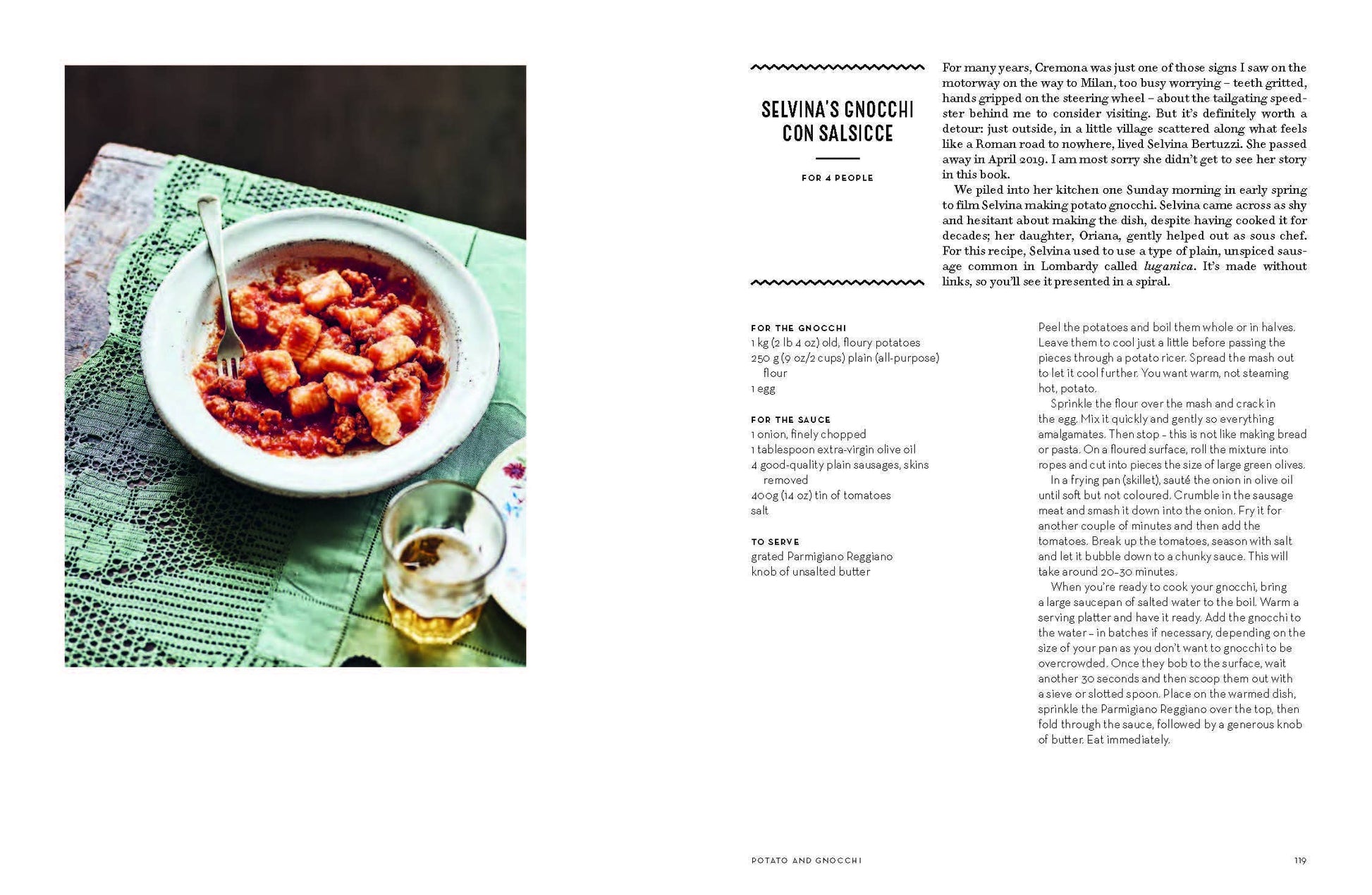 Recipe page with a bowl of pasta and a glass of wine on a green tablecloth.