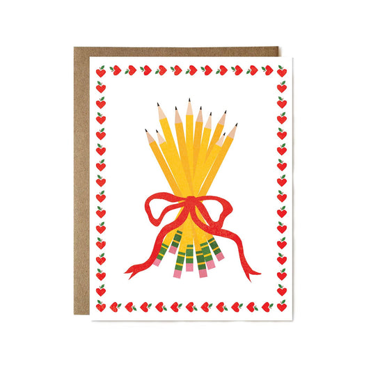 Greeting card with a design of yellow pencils tied with a red ribbon, surrounded by small red hearts on a white background.