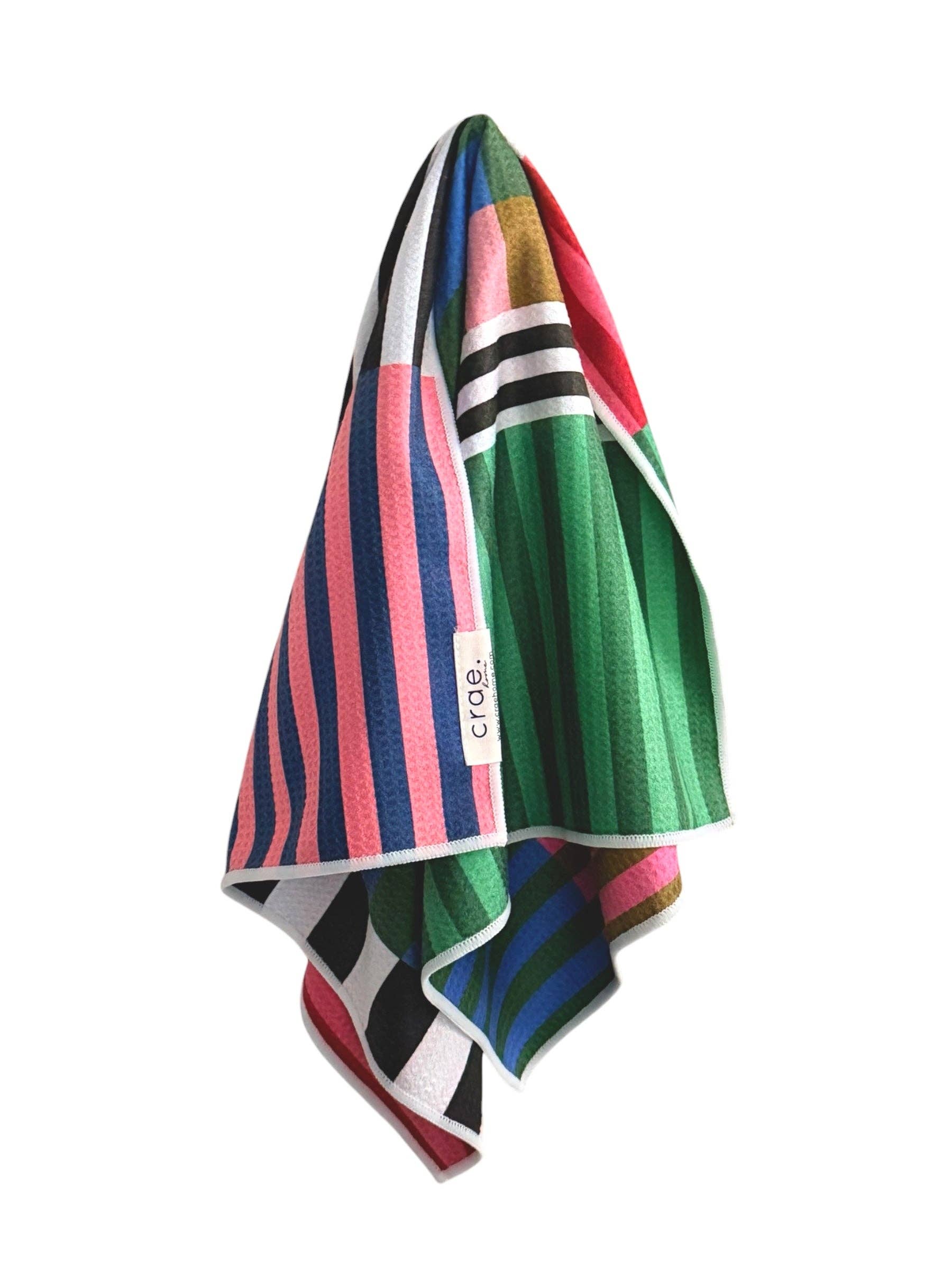 Colorful striped towel with a brand logo on a white background