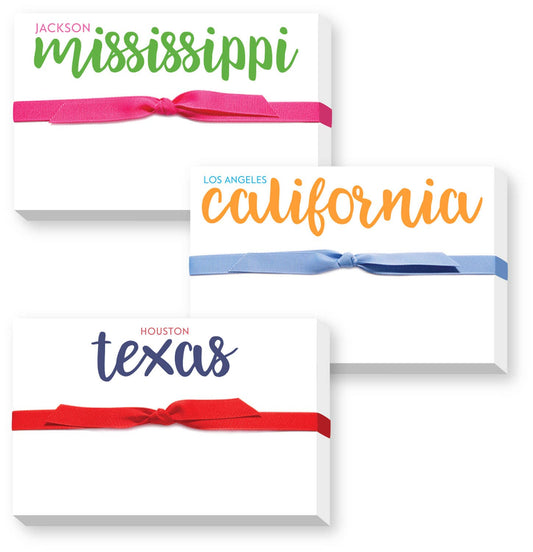 Three gift boxes with ribbons labeled 'Jackson, Mississippi', 'Los Angeles, California', and 'Houston, Texas' on a white background.