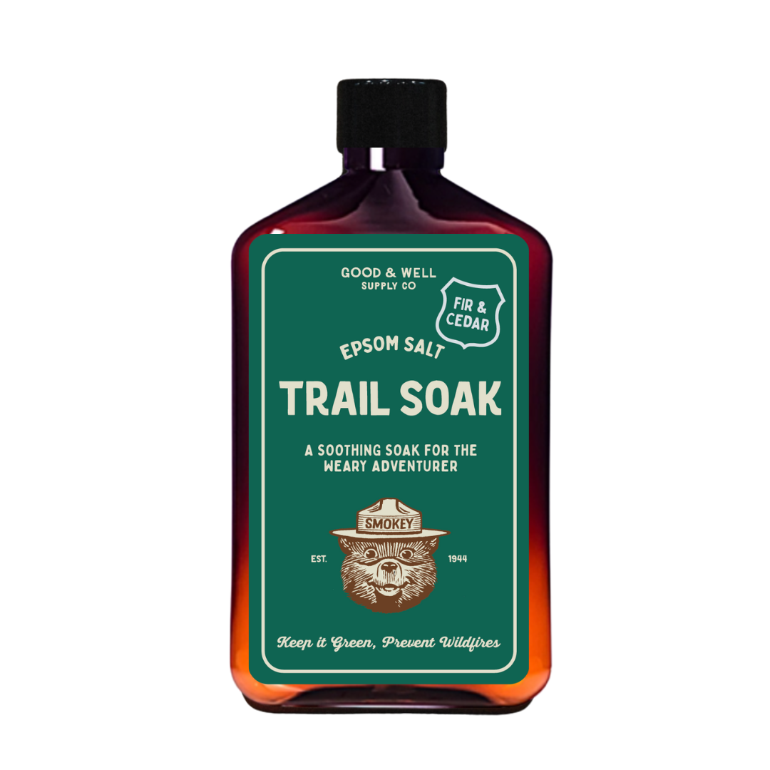 Bottle of Epsom salt trail soak with a green label on a white background