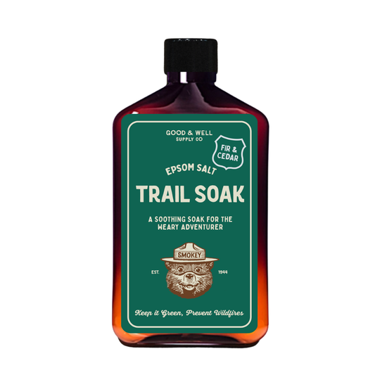 Bottle of Epsom salt trail soak with a green label on a white background