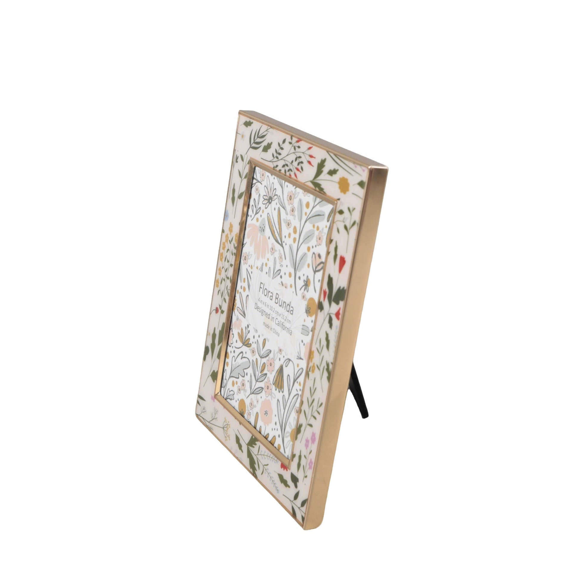 Side view of a decorative photo frame with floral design on a white background