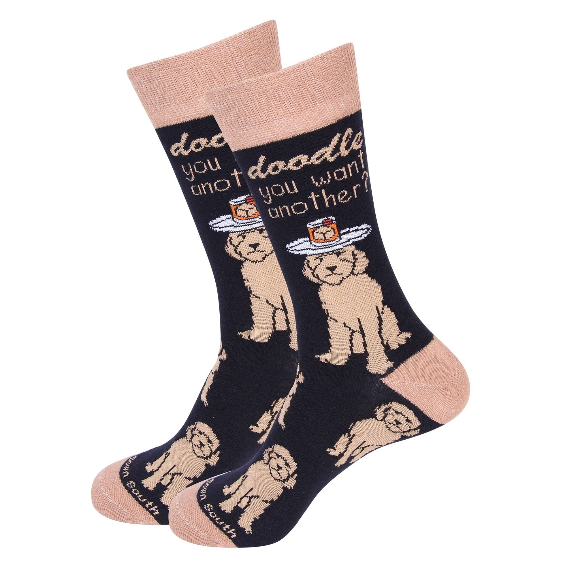 Pair of socks with doodle dog holding a tray with a rocks glass on its head and text reading "Doodle you want another?" on a white background