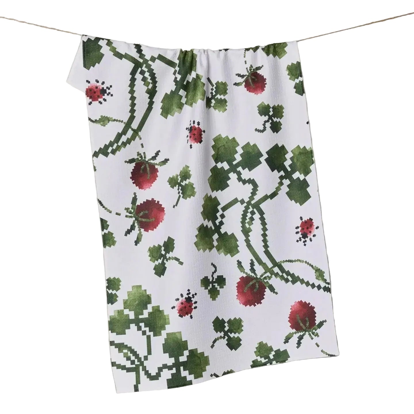 Floral patterned towel hanging on a line against a neutral background