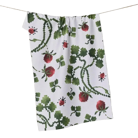 Floral patterned towel hanging on a line against a neutral background