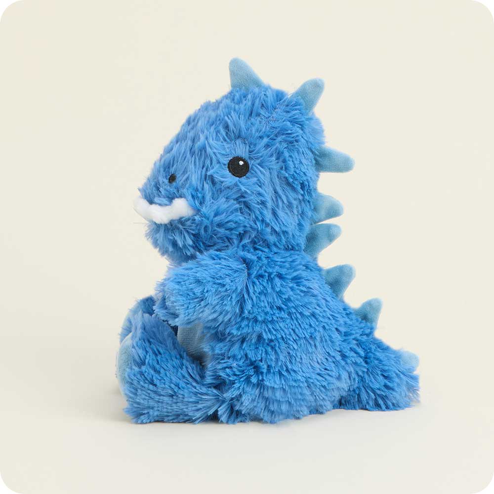 Blue plush dragon toy on a light beige background