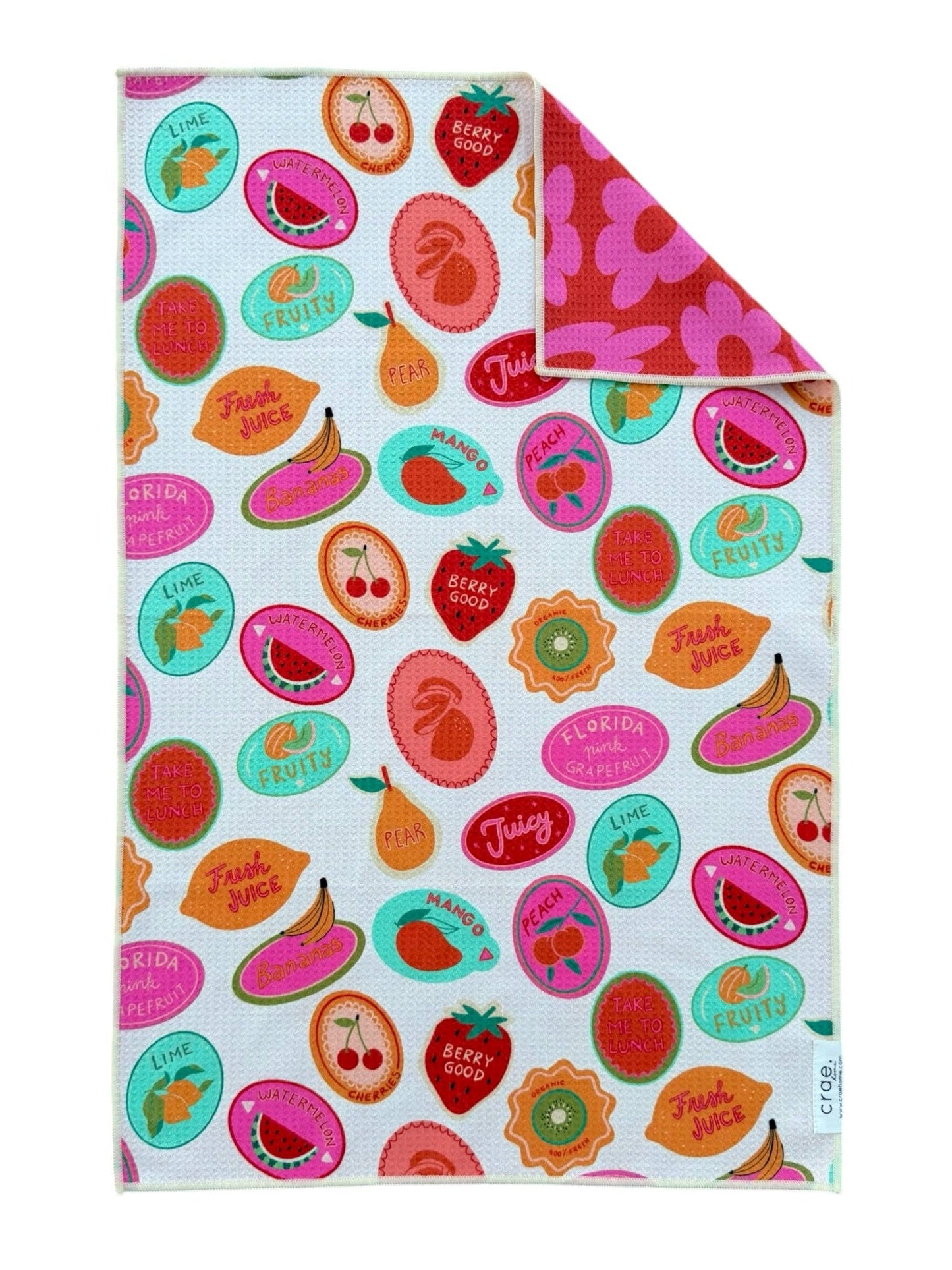Colorful fruit-themed towel with text on a white background