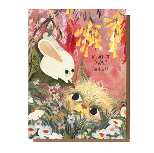 Greeting card with cartoon cat and rabbit in a floral setting and text 'You are my favorite creature'.