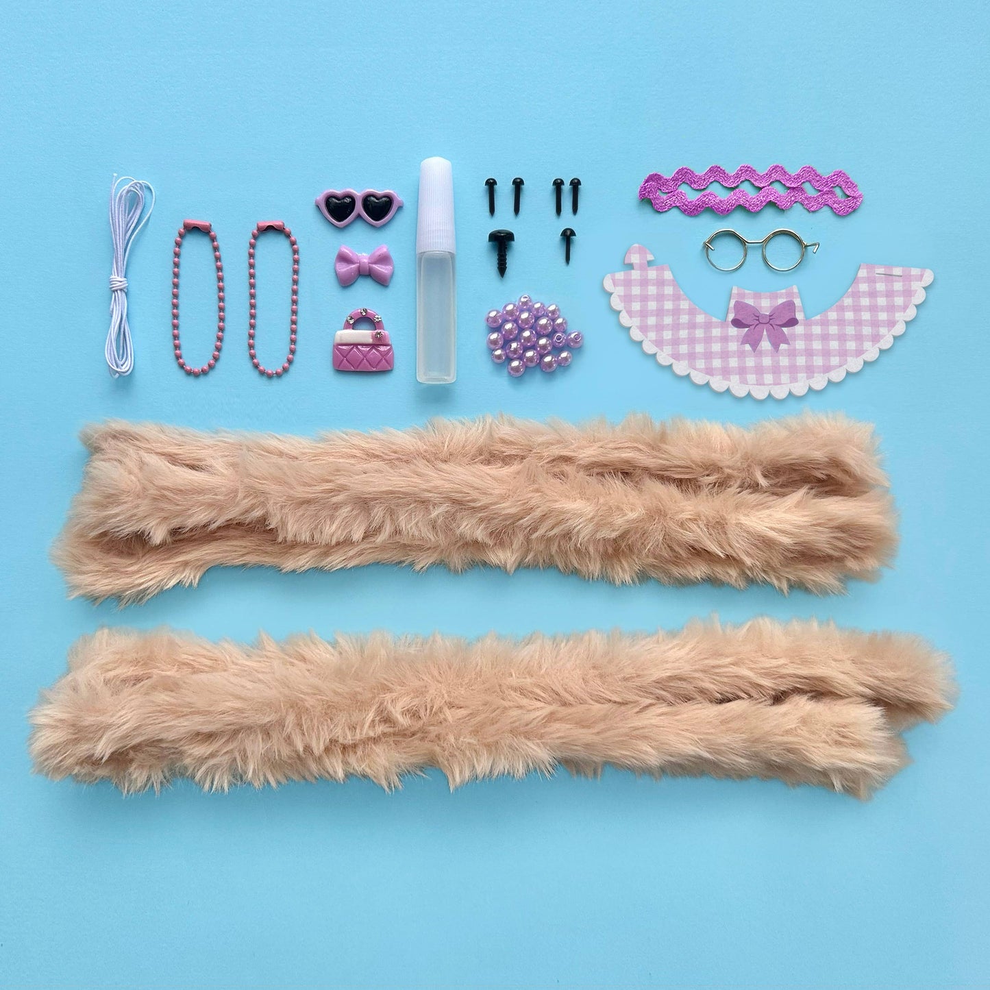 Collection of accessories including fluffy sticks, beads, and decorative items on a blue background