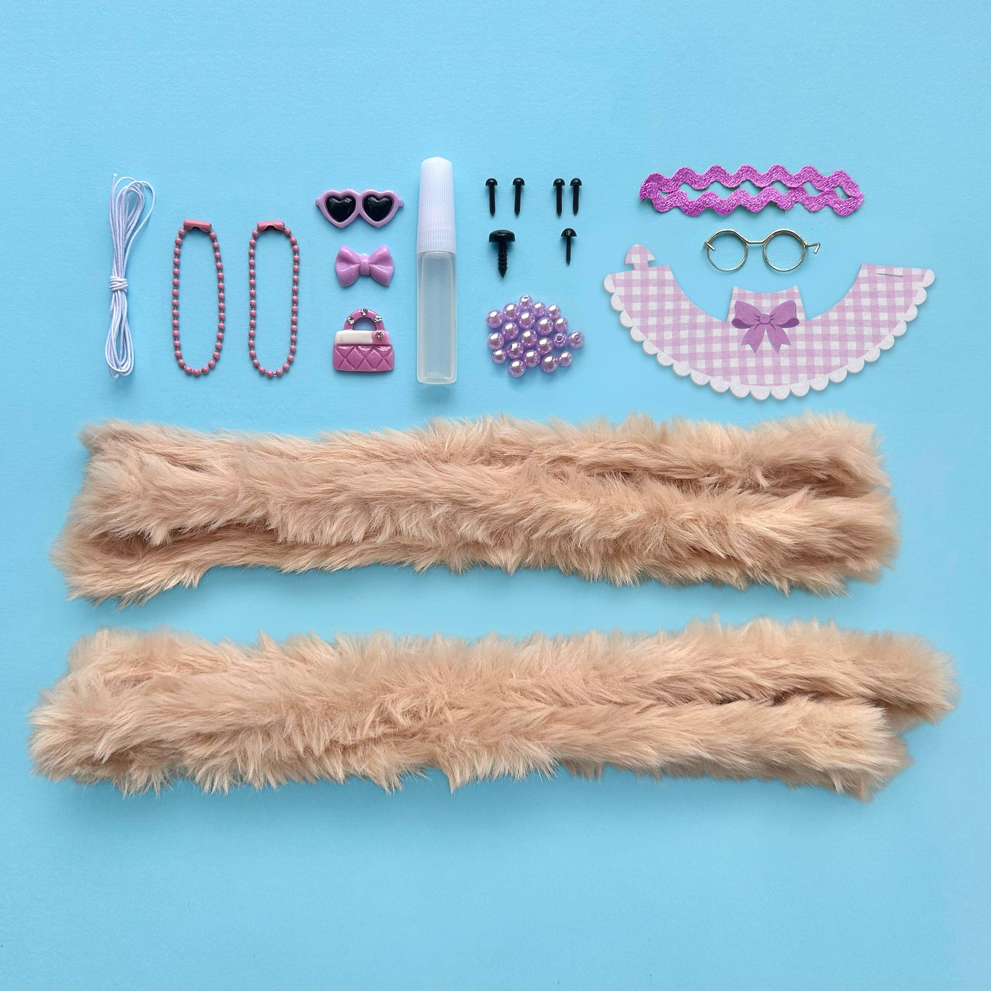 Collection of accessories including fluffy sticks, beads, and decorative items on a blue background