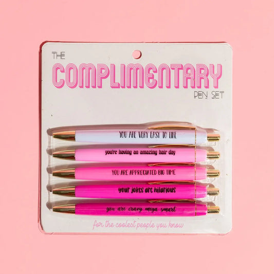 Set of pens in packaging with humorous text on a pink background
