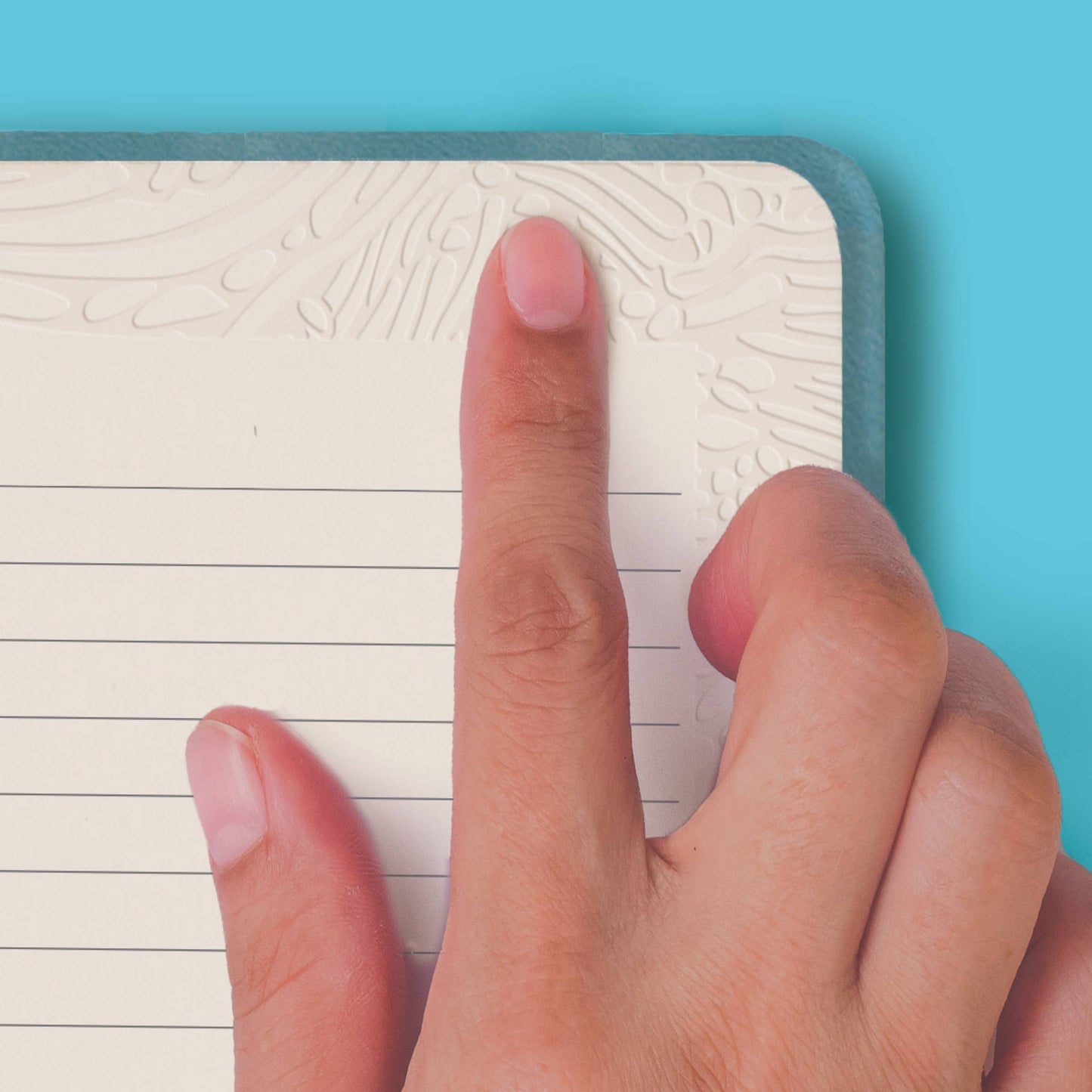 Finger touching texture page of notebook, showing tactile pages feature