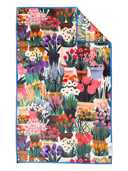 Colorful blanket with floral and potted plant pattern