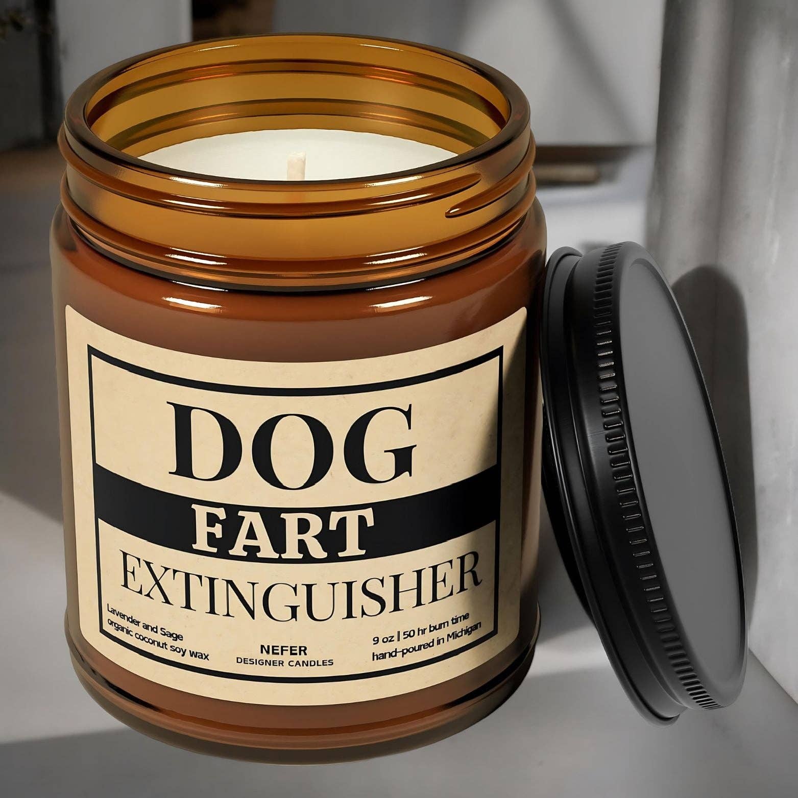 Funny candle with the text "Dog Fart Extinguisher" on a gray background