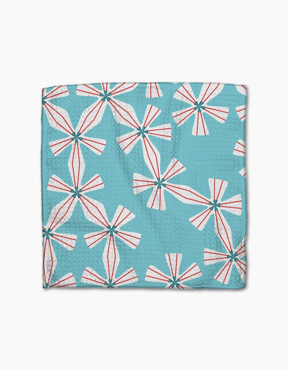 Teal towel with pink and white geometric pattern on a white background