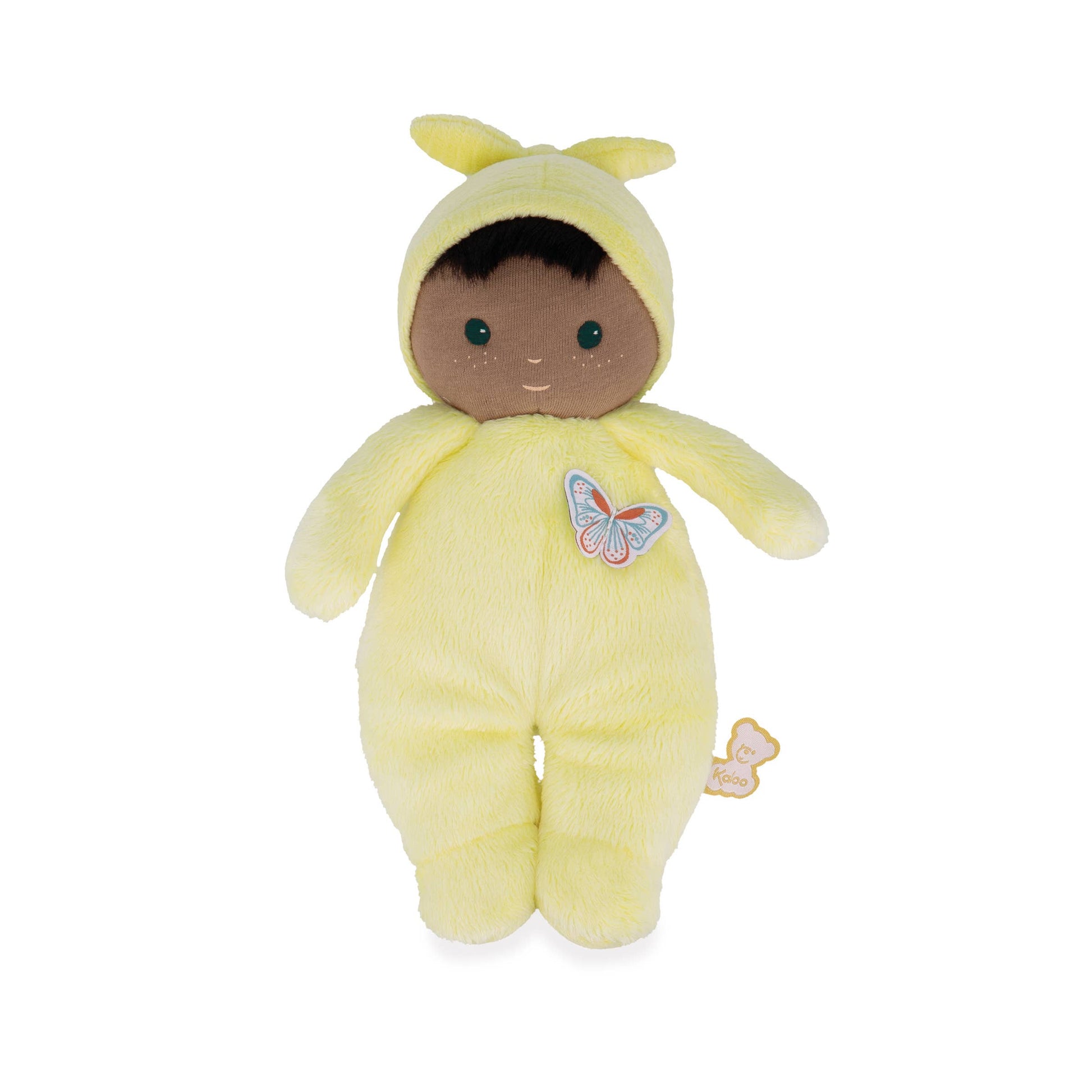 Plush toy baby doll in a yellow outfit with a butterfly patch on a white background