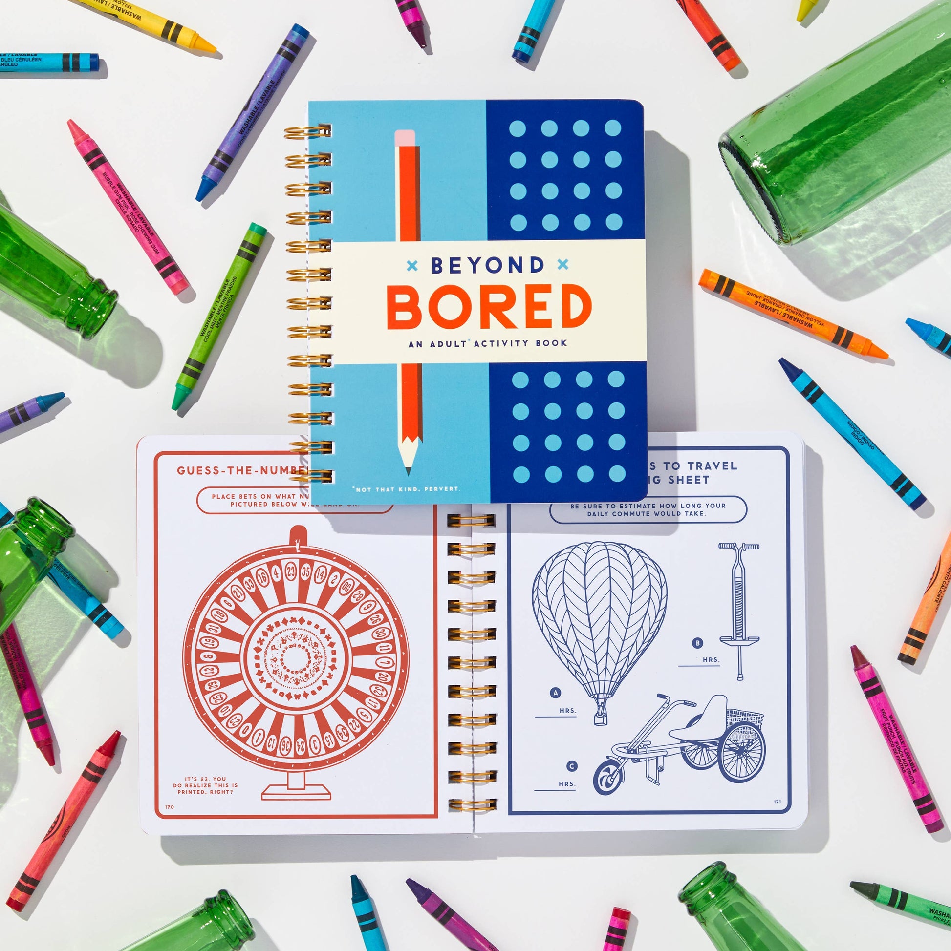 Activity book titled 'Beyond Bored' with colorful crayons and markers on a white background